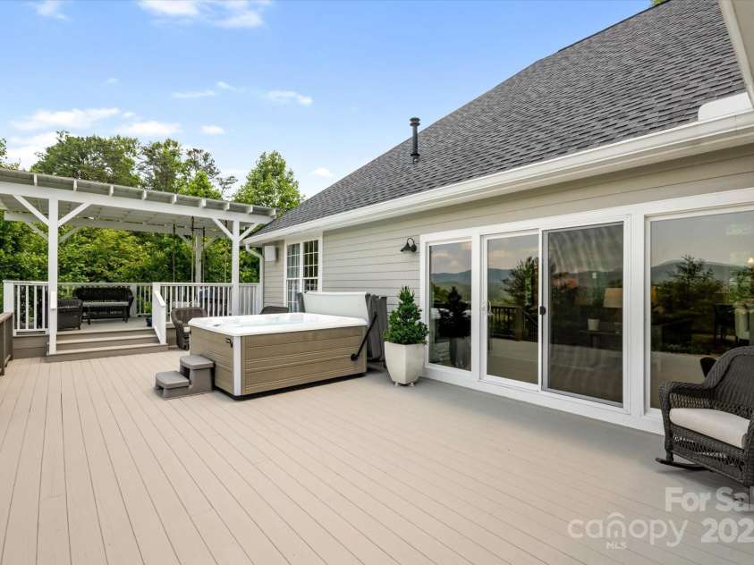 225 Calm Creek Road, Fletcher, NC 28732.  MLS# CAR4275540, YatesRealty ID 31254. Escape to the shade under the pergola and take a nap on the porch swing bed