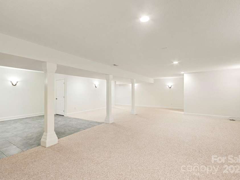 225 Calm Creek Road, Fletcher, NC 28732.  MLS# CAR4275540, YatesRealty ID 31254. Expansive finished basement is plenty of room for whatever your heart desires.