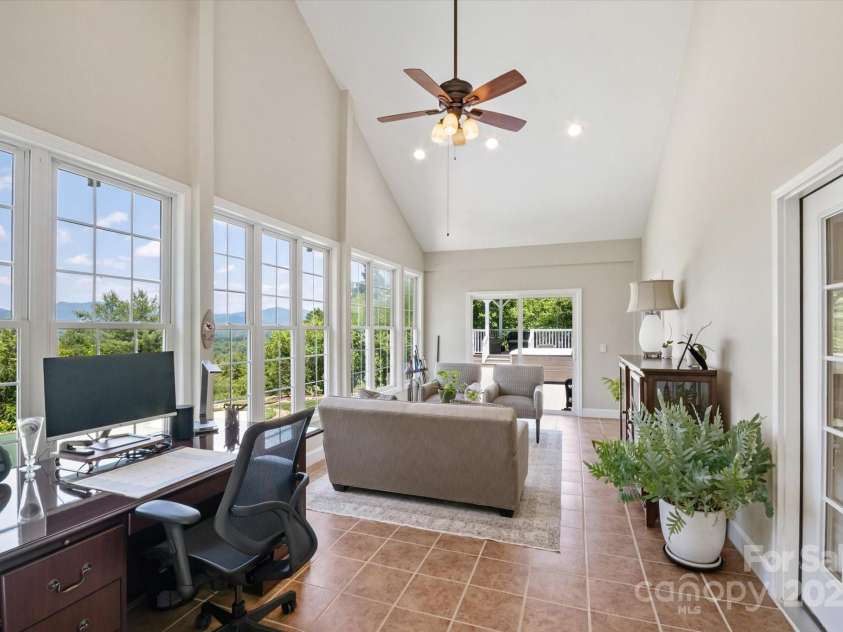 225 Calm Creek Road, Fletcher, NC 28732.  MLS# CAR4275540, YatesRealty ID 31254. Four season room also leads out to expansive deck and hot tub.