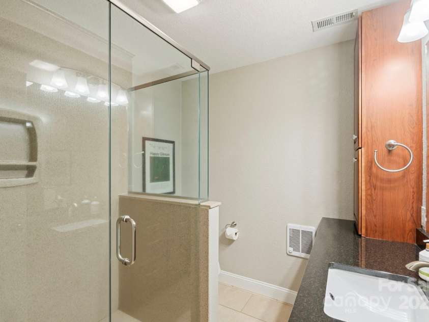 225 Calm Creek Road, Fletcher, NC 28732.  MLS# CAR4275540, YatesRealty ID 31254. Full bath with walk in shower in basement