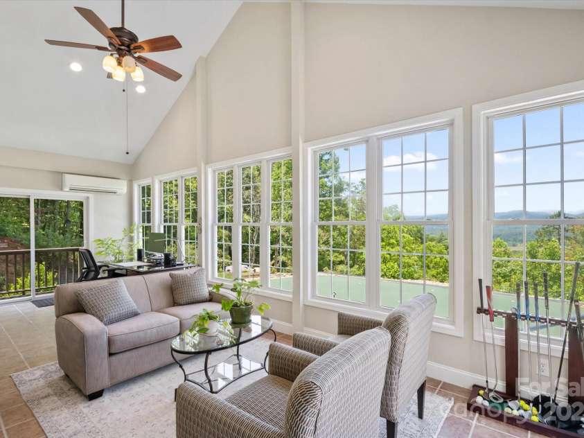 225 Calm Creek Road, Fletcher, NC 28732.  MLS# CAR4275540, YatesRealty ID 31254. Light, airy four season room overlooking putting  green.