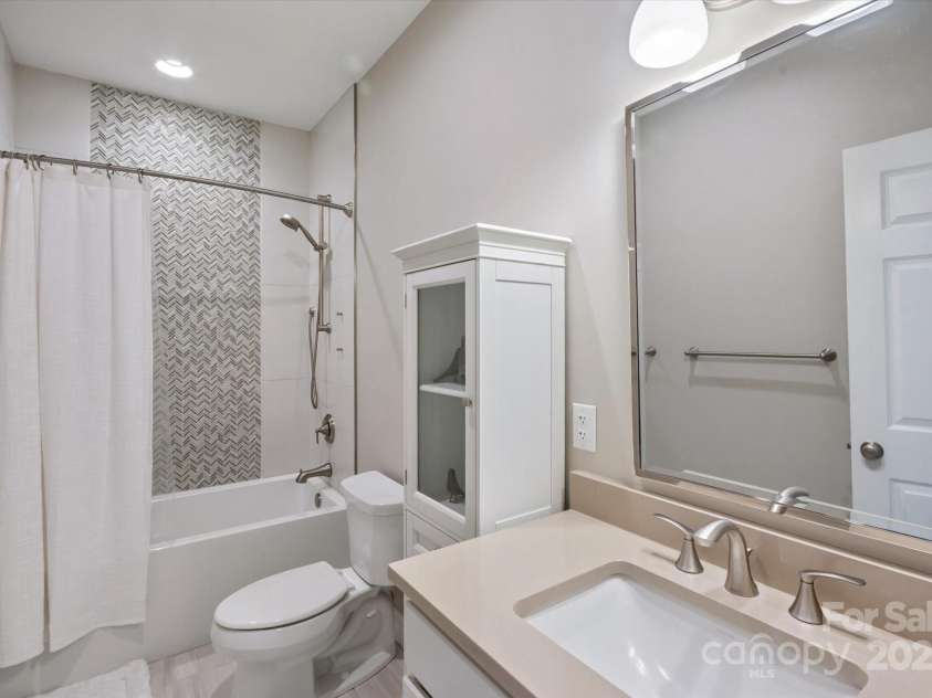 225 Calm Creek Road, Fletcher, NC 28732.  MLS# CAR4275540, YatesRealty ID 31254. Updated guest bath with beautifully tiled shower