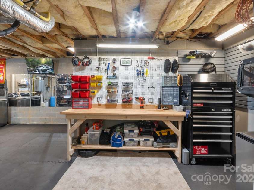 225 Calm Creek Road, Fletcher, NC 28732.  MLS# CAR4275540, YatesRealty ID 31254. Work area in basement