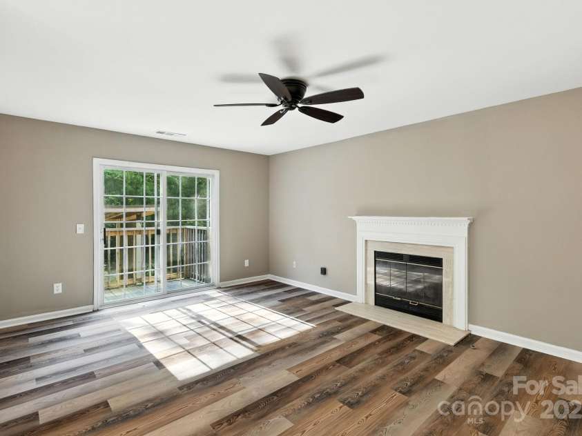 9003 Steelechase Drive, Charlotte, NC 28273.  MLS# CAR4288220, YatesRealty ID 31275. Family Room with access outside and a cozy gas fireplace with gas logs
