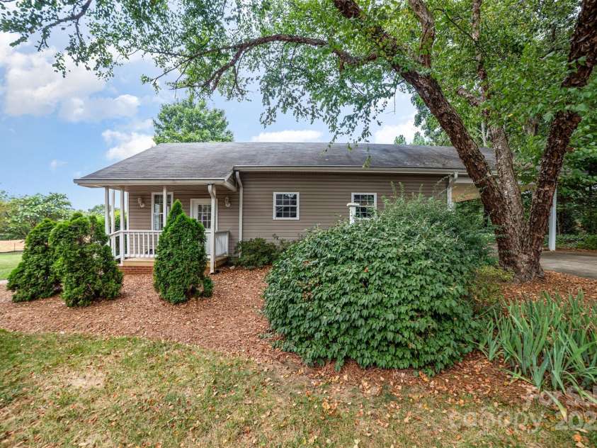 415 Greenbriar Road, Statesville, NC 28625.  MLS# CAR4288246, YatesRealty ID 31286. Additional square footage in outbuilding with quaint front porch and carport.