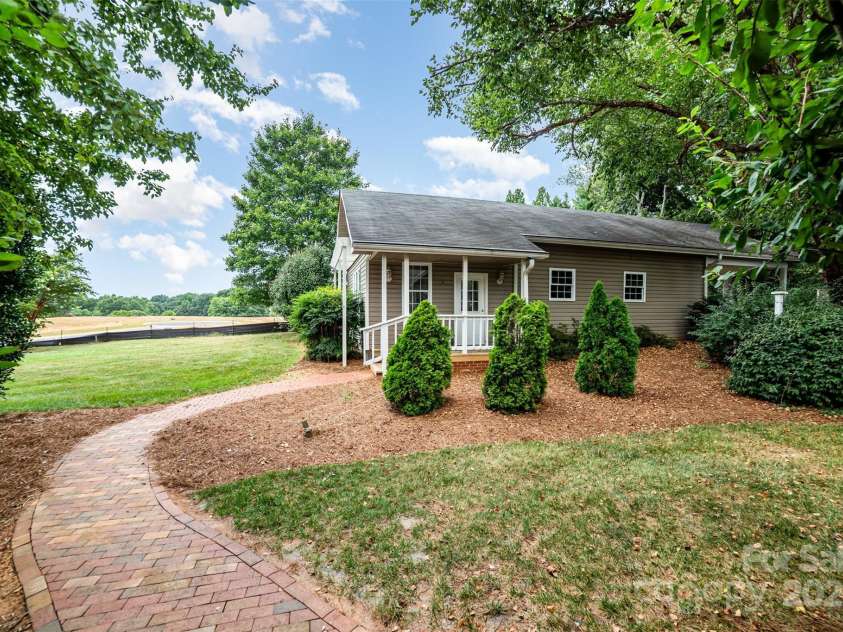415 Greenbriar Road, Statesville, NC 28625.  MLS# CAR4288246, YatesRealty ID 31286. Outbuilding includes finished area perfect for man cave, she shed, craft or hobby area and large workshop. Adjoining is a carport large enough for an RV.
