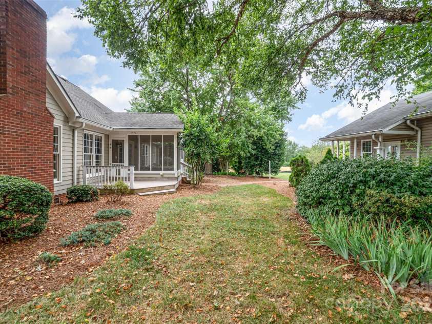 415 Greenbriar Road, Statesville, NC 28625.  MLS# CAR4288246, YatesRealty ID 31286. View of back of home and outbuilding with extra finished space and work shop.