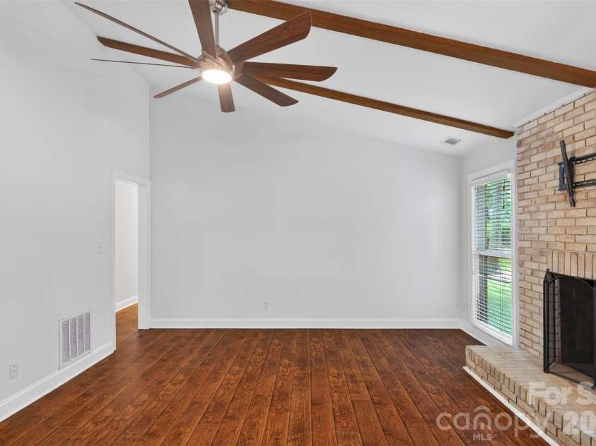 7148 Powder Mill Place, Charlotte, NC 28277.  MLS# CAR4379444, YatesRealty ID 31287. The kitchen flows into the family room with soaring ceilings and wood burning fireplace