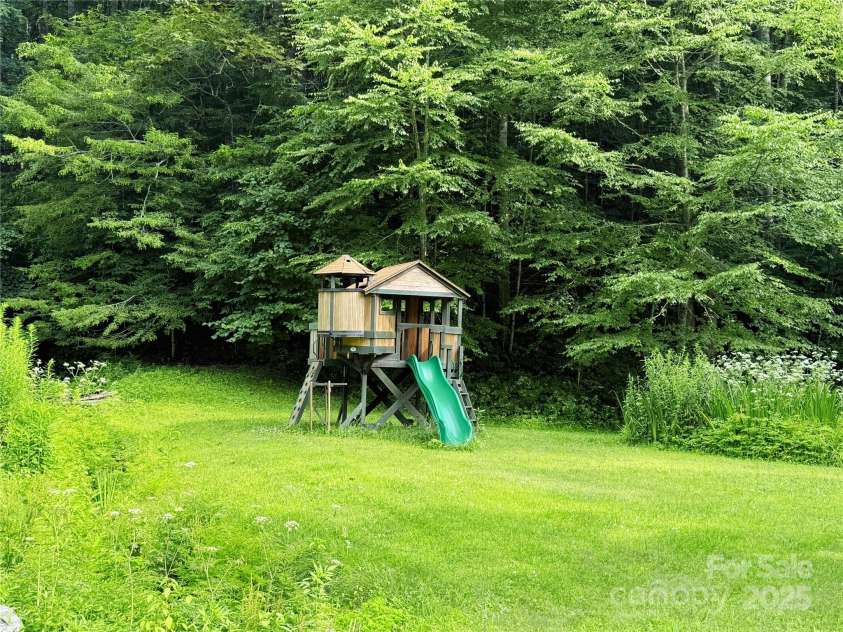 226 Wildcat Mountain Trail, Sylva, NC 28779.  MLS# CAR4284312, YatesRealty ID 31290. Playset next to pond