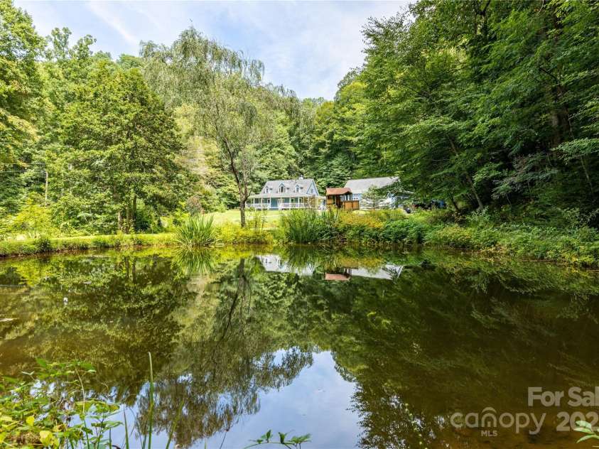 226 Wildcat Mountain Trail, Sylva, NC 28779.  MLS# CAR4284312, YatesRealty ID 31290. View of home from the spring fed pond