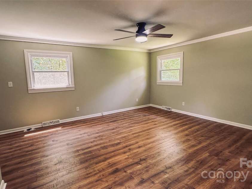 2680 Peachtree Road, Statesville, NC 28625.  MLS# CAR4290683, YatesRealty ID 31333. Spacious primary bedroom with fresh flooring and paint - move-in ready comfort.