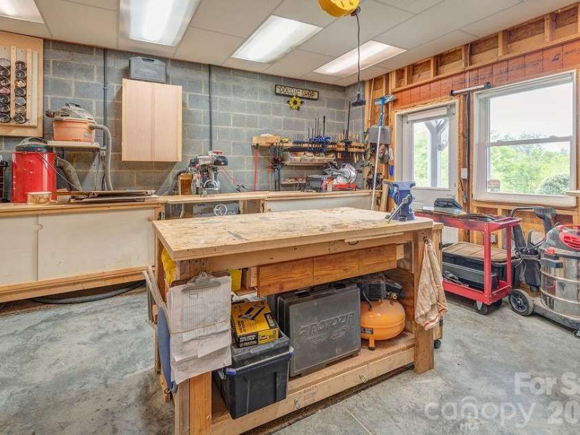 18 Adas Way, Weaverville, NC 28787.  MLS# CAR4385497, YatesRealty ID 31334. A dedicated workshop with exterior access offers the perfect space for projects, hobbies, and hands-on pursuits
