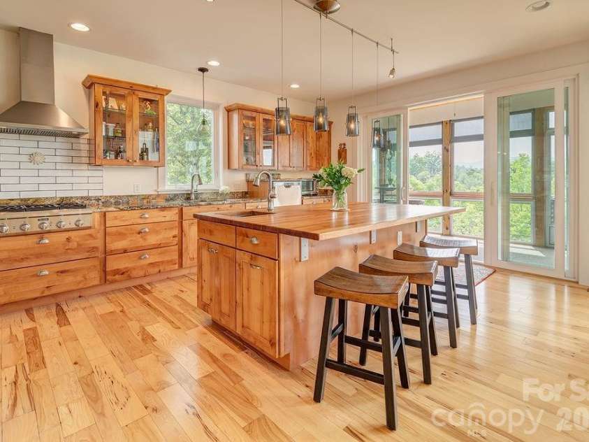 18 Adas Way, Weaverville, NC 28787.  MLS# CAR4385497, YatesRealty ID 31334. Deep pull-out self-closing drawers, sliding pantry drawers, a raised dishwasher, and toe-touch trash cans bring inspired functionality to every inch of this chef's kitchen