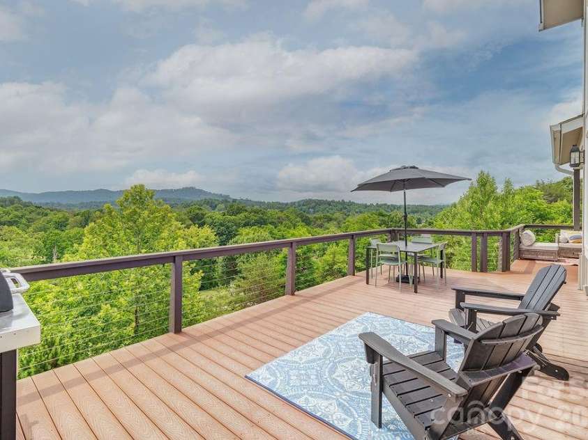 18 Adas Way, Weaverville, NC 28787.  MLS# CAR4385497, YatesRealty ID 31334. Expansive decks extend the living spaces outdoors, offering multiple areas for dining, relaxing, and soaking in the surrounding mountain beauty