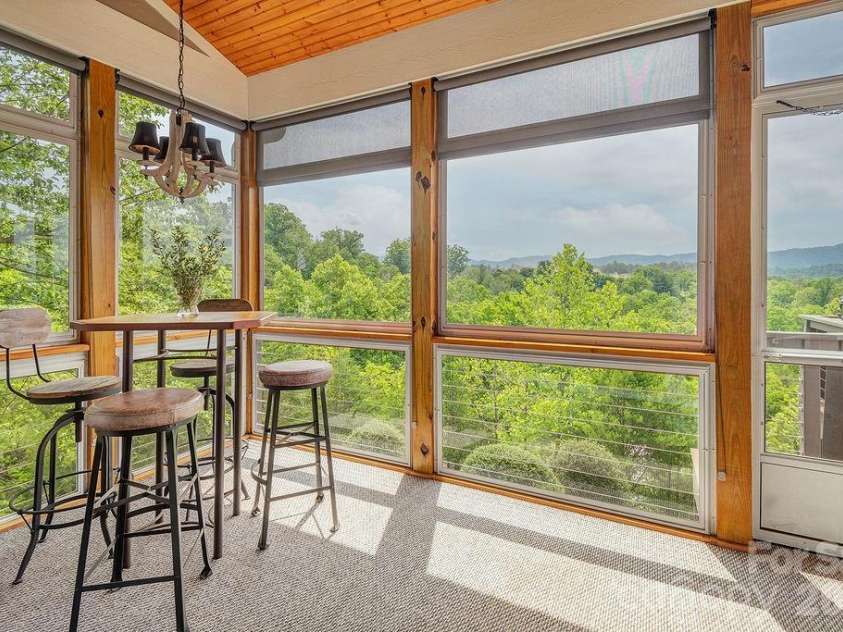 18 Adas Way, Weaverville, NC 28787.  MLS# CAR4385497, YatesRealty ID 31334. The kitchen opens gracefully to a three-season room where mountain breezes and spectacular scenery make every meal and gathering feel like a celebration