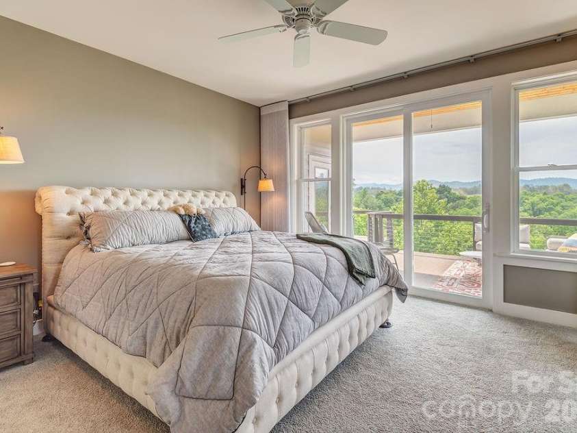 18 Adas Way, Weaverville, NC 28787.  MLS# CAR4385497, YatesRealty ID 31334. The large main level primary bedroom features gorgeous mountain views 