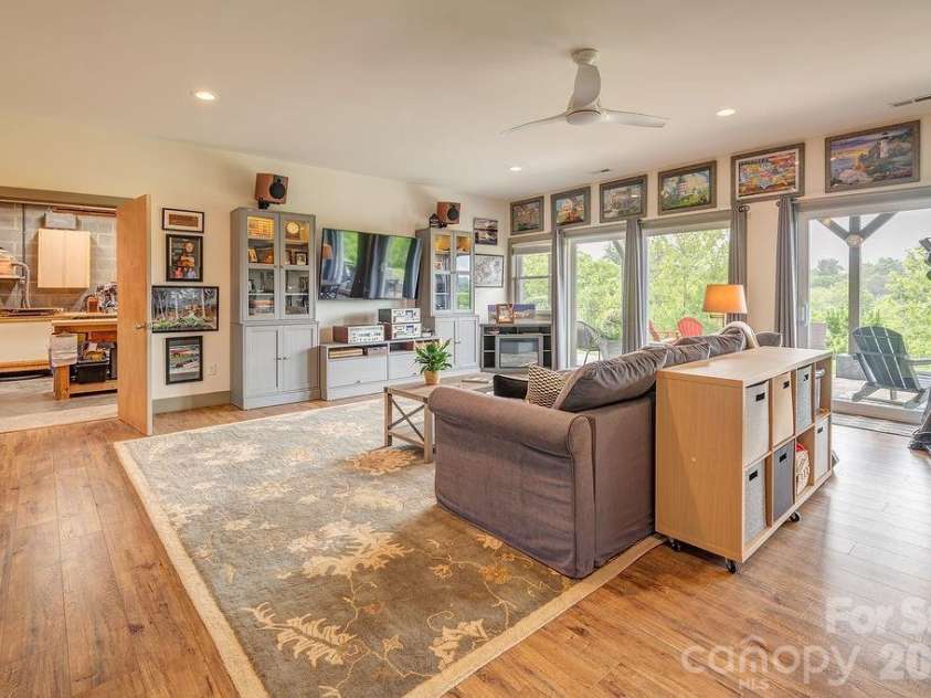 18 Adas Way, Weaverville, NC 28787.  MLS# CAR4385497, YatesRealty ID 31334. The lower level den room offers exceptional flexibility — imagine it as a den, studio, guest retreat, or all three — flooded with natural light and framed by the mountains beyond