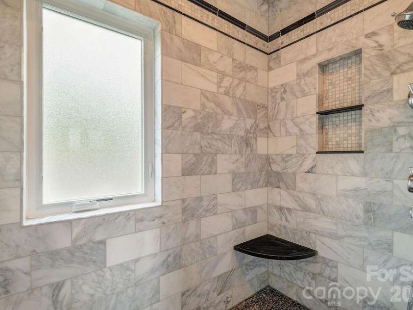 18 Adas Way, Weaverville, NC 28787.  MLS# CAR4385497, YatesRealty ID 31334. The primary en suite features a grand stone-and-tile shower, give you a private spa experience, every single day