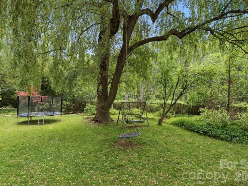 11 Echo Lake Drive, Fairview, NC 28730.  MLS# CAR4387481, YatesRealty ID 31338. Green Space Surrounds Weeping Willow