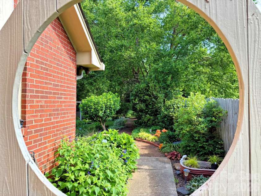 7029 Forest Hills Drive, Denver, NC 28037.  MLS# CAR4386920, YatesRealty ID 31346. Side of house looking into backyard