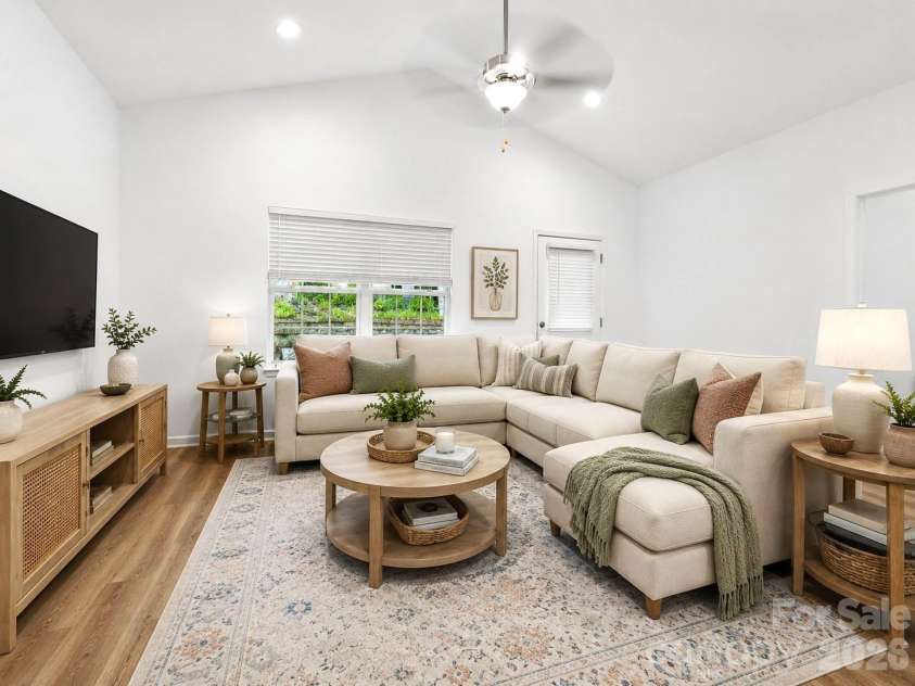 103 Trexler Avenue, Mount Holly, NC 28120.  MLS# CAR4387325, YatesRealty ID 31349. The open-concept great room features vaulted ceilings, abundant natural light, and seamless flow into the kitchen, creating the perfect space for relaxing, entertaining, and everyday living. Virtually Staged.