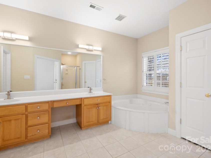 9433 Gilpatrick Lane, Huntersville, NC 28078.  MLS# CAR4231980, YatesRealty ID 3137. Primary Ensuite bath with Dual Vanities - Shower - and Whirlpool and separate toilet room