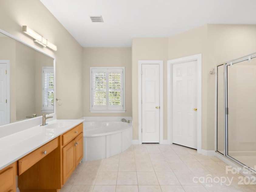 9433 Gilpatrick Lane, Huntersville, NC 28078.  MLS# CAR4231980, YatesRealty ID 3137. Primary Ensuite bath with Dual Vanities - Shower - and Whirlpool and separate toilet room
