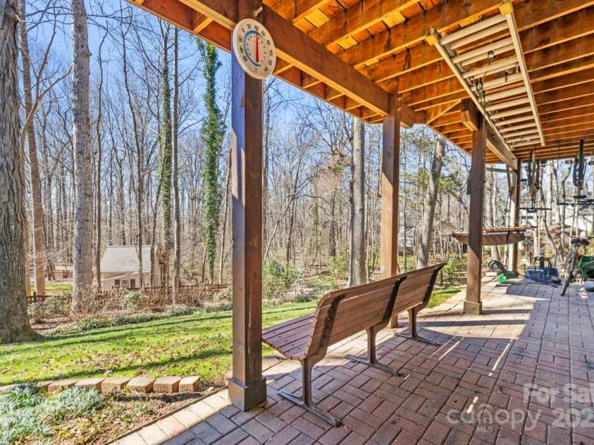 8802 Glenside Street, Huntersville, NC 28078.  MLS# CAR4316716, YatesRealty ID 31376. Patio under porch and deck is a great place to hang bikes, especially if you are going out the backyard gate onto the Greenway.