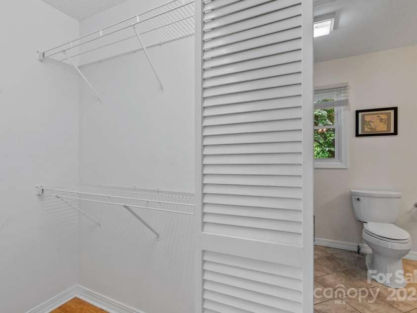 4-B HedgeRose Court, Asheville, NC 28805.  MLS# CAR4258653, YatesRealty ID 31392. Double walk in closets opposite each other between bathroom and bedroom of primary...