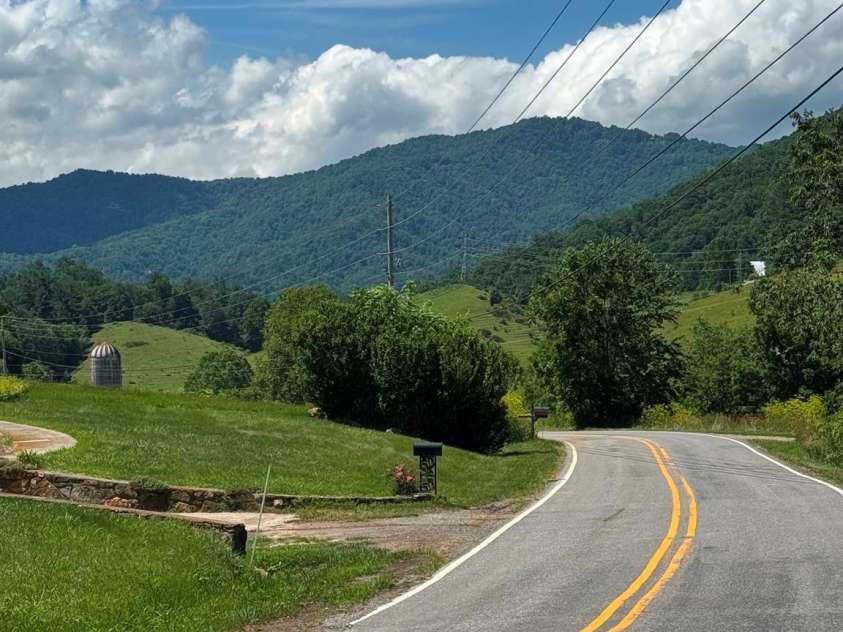 686 Hyacinth Drive, Clyde, NC 28721.  MLS# CAR4384299, YatesRealty ID 31392. Panther Creek Road at intersection with Van Arrington, looking north