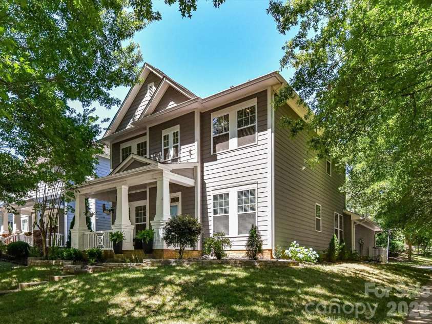 17404 Harbor Walk Drive, Cornelius, NC 28031.  MLS# CAR4393057, YatesRealty ID 31396. A charming two-story home, located on a corner lot, with classic Craftsman-inspired architecture, a welcoming covered front porch, and mature shade trees creating exceptional curb appeal.