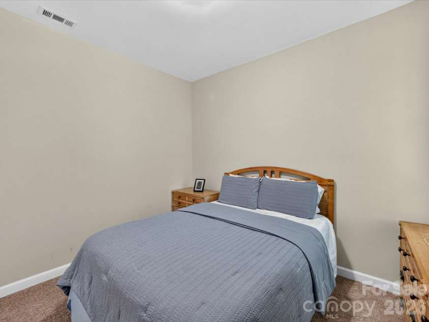 17404 Harbor Walk Drive, Cornelius, NC 28031.  MLS# CAR4393057, YatesRealty ID 31396. Bedroom 2 provides a comfortable and versatile space with soft carpeting, abundant natural light, and room for both relaxation and productivity.