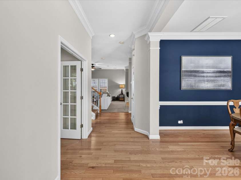 17404 Harbor Walk Drive, Cornelius, NC 28031.  MLS# CAR4393057, YatesRealty ID 31396. The bright and welcoming foyer features attractive wood floors, elegant crown molding, and an open layout that creates a warm first impression while seamlessly connecting the home's living spaces.