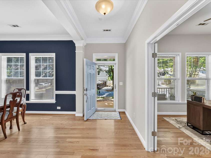 17404 Harbor Walk Drive, Cornelius, NC 28031.  MLS# CAR4393057, YatesRealty ID 31396. The bright and welcoming foyer features wood floors, elegant crown molding, and an open layout that creates a warm first impression while seamlessly connecting the home's living spaces.