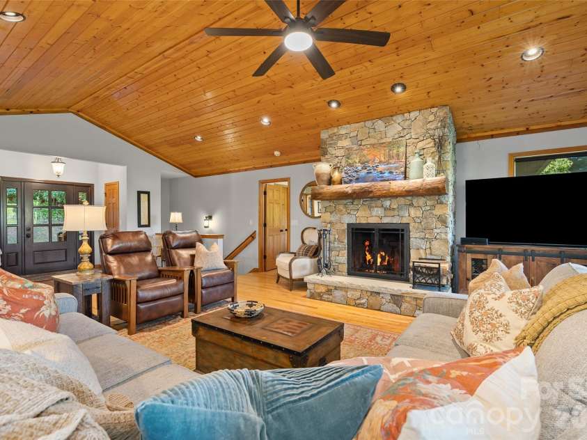 359 Saddlebrook Lane, Clyde, NC 28721.  MLS# CAR4393520, YatesRealty ID 31400. Living Room with stone fireplace