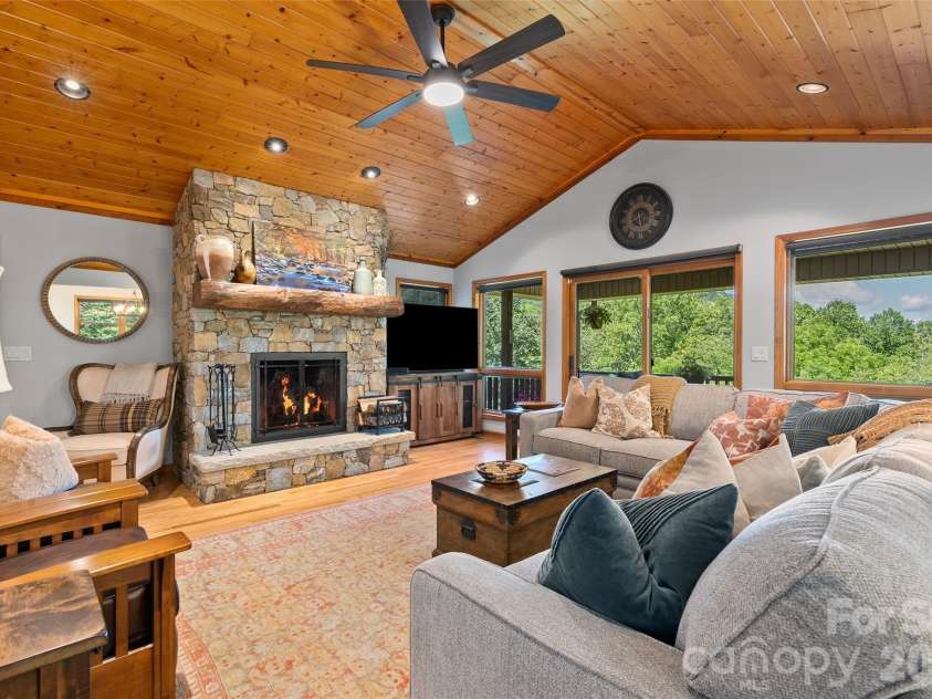 359 Saddlebrook Lane, Clyde, NC 28721.  MLS# CAR4393520, YatesRealty ID 31400. Living room with walkout to covered deck