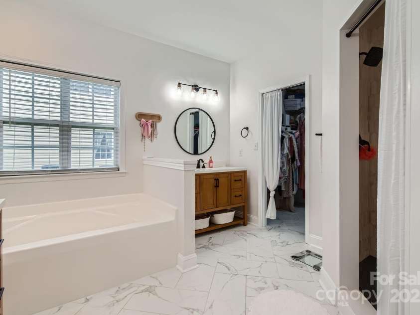4120 Waxwood Drive, Monroe, NC 28110.  MLS# CAR4279472, YatesRealty ID 31408. Renovated spa-like bathroom with soaking tub & large beautifully tiled shower.