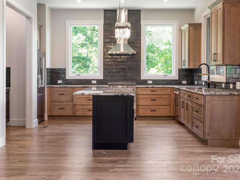 129 Parkway View Drive, Hendersonville, NC 28739.  MLS# CAR4258845, YatesRealty ID 31411. Chef's kitchen with granite, custom cabinetry, with ZLINE & LG slim stainless steel appliances