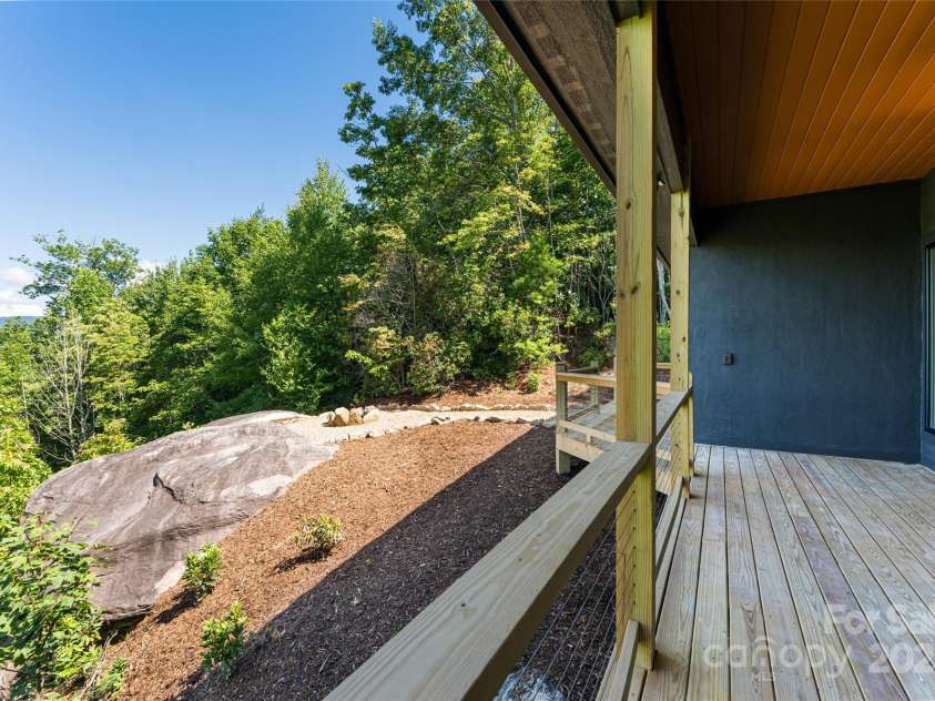 129 Parkway View Drive, Hendersonville, NC 28739.  MLS# CAR4258845, YatesRealty ID 31411. Deck flows to rock outcropping and fire-it