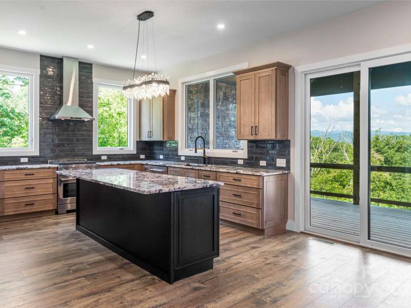 129 Parkway View Drive, Hendersonville, NC 28739.  MLS# CAR4258845, YatesRealty ID 31411. Expansive sliding doors lead to covered deck