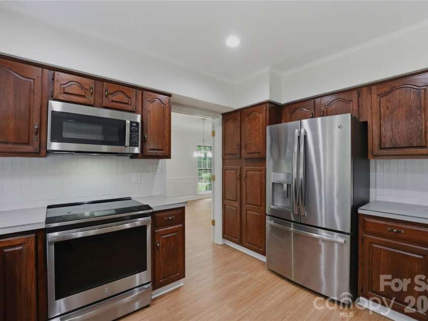 2341 Hamilton Mill Road, Charlotte, NC 28270.  MLS# CAR4391403, YatesRealty ID 31412. Kitchen leads to large dining room.