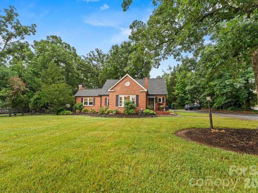 1832 Badin Road, Albemarle, NC 28001.  MLS# CAR4392071, YatesRealty ID 31414. Front view from Badin Road.  Beautifully landscaped.