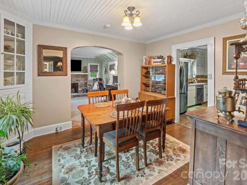 1832 Badin Road, Albemarle, NC 28001.  MLS# CAR4392071, YatesRealty ID 31414. The second arched opening in the dining room leads to a nice sized den that opens to the deck outside.