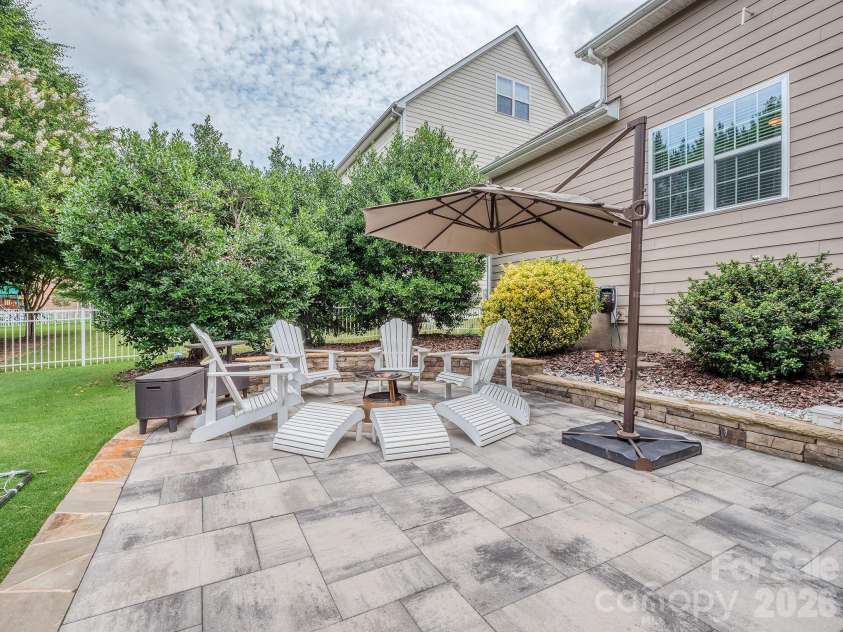4312 Oxford Mill Road, Waxhaw, NC 28173.  MLS# CAR4390150, YatesRealty ID 31418. Backyard hardscape with firepit area
