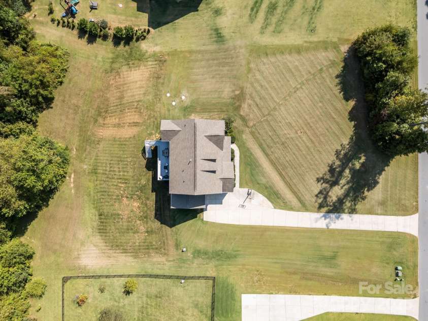 141 Rain Shadow Drive, Mooresville, NC 28115.  MLS# CAR4305913, YatesRealty ID 3144. Full 1.31 lot, Rear property line goes beyond trees