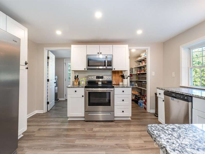 754 Rubens Road, Concord, NC 28027.  MLS# CAR4283491, YatesRealty ID 31457. Laundry Room sits to the left side off kitchen and there is a large walk in pantry.