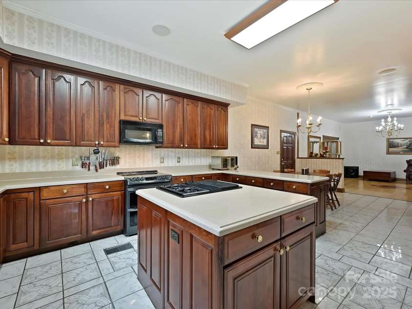 4900 Rocky River Road, Charlotte, NC 28215.  MLS# CAR4283934, YatesRealty ID 31470. Custom Chefs kitchen has electric & gas stoves
