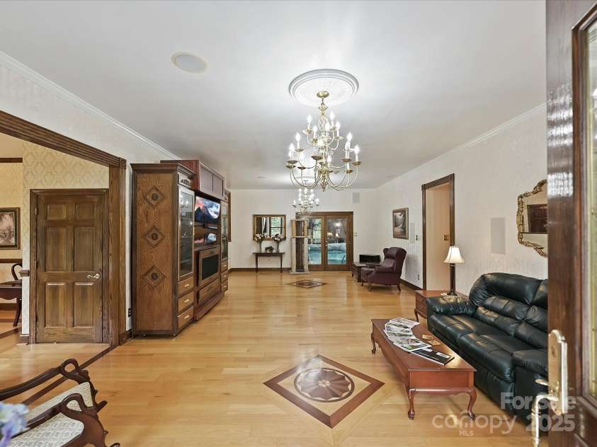 4900 Rocky River Road, Charlotte, NC 28215.  MLS# CAR4283934, YatesRealty ID 31470. Entry into LR showing double slide door leading to indoor pool
