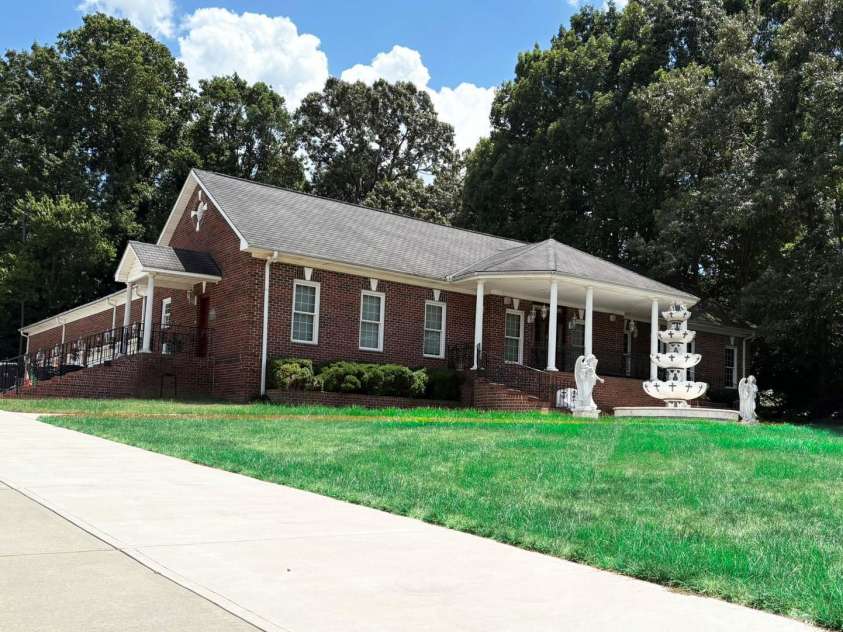 4900 Rocky River Road, Charlotte, NC 28215.  MLS# CAR4283934, YatesRealty ID 31470. Front/side view of house showing garage