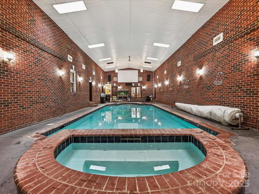 4900 Rocky River Road, Charlotte, NC 28215.  MLS# CAR4283934, YatesRealty ID 31470. Indoor pool area leads into LR, BR, Primary BR, Half bath, Solarium & Garage